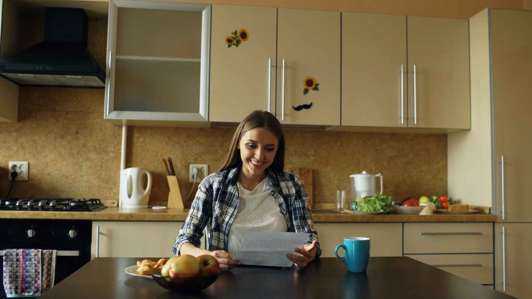 A person reading a document at a kitchen table with coffee